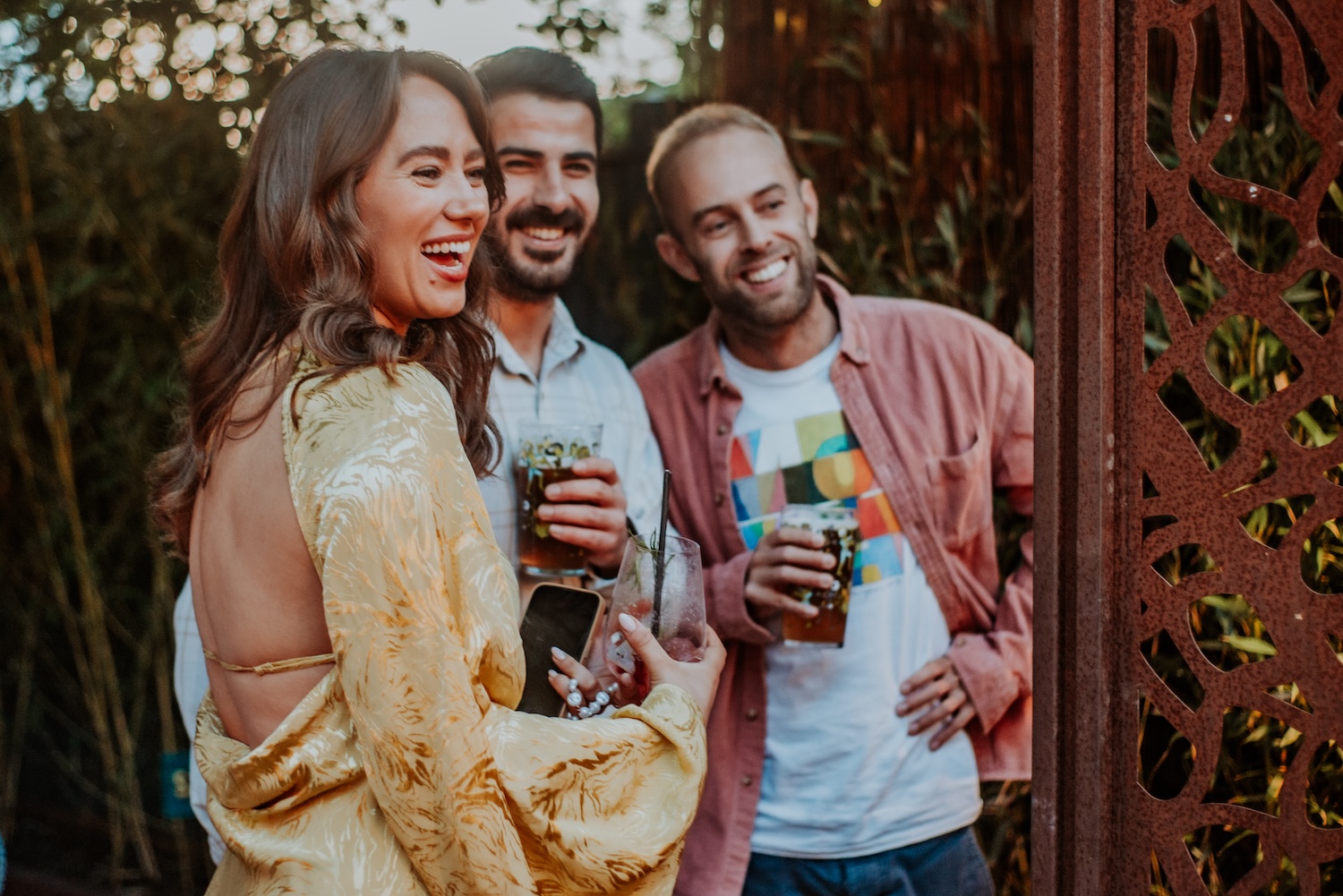 A vibrant shot of three guests enjoying drinks and laughter in the outdoor area of The Square Club, a popular private party venue in Bristol. The lush greenery and warm atmosphere make this events space ideal for relaxed and memorable gatherings.