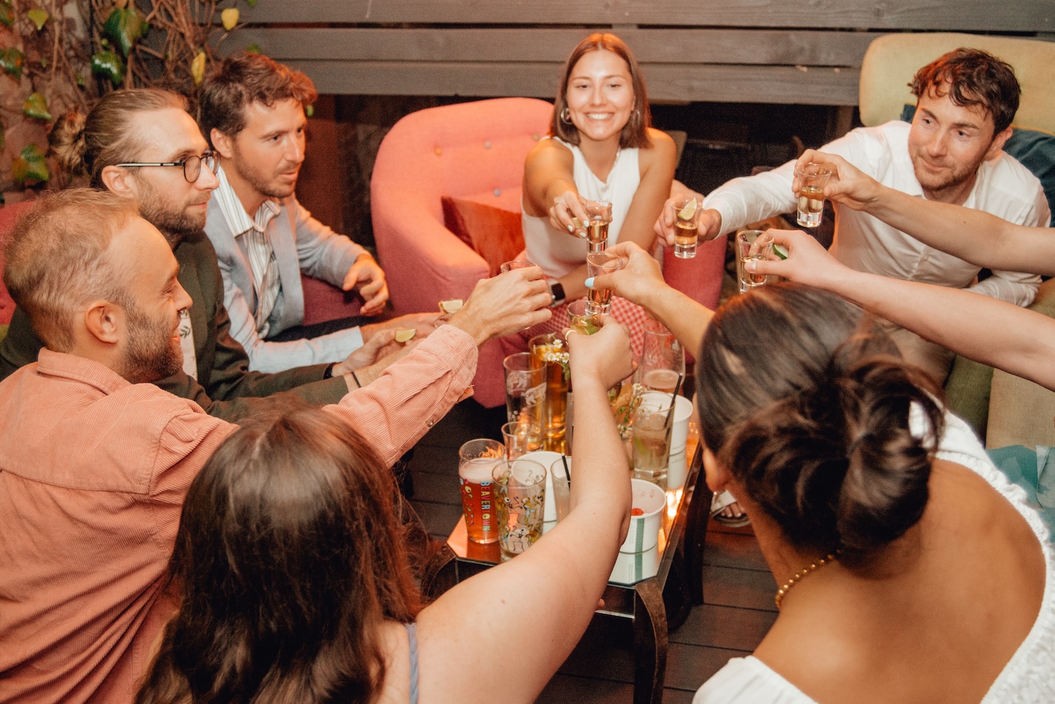 A group of friends raising tequila shots in unison at The Square Club, capturing the festive atmosphere of this private party venue in Bristol. The intimate seating area with soft lighting is perfect for casual celebrations and lively get-togethers.