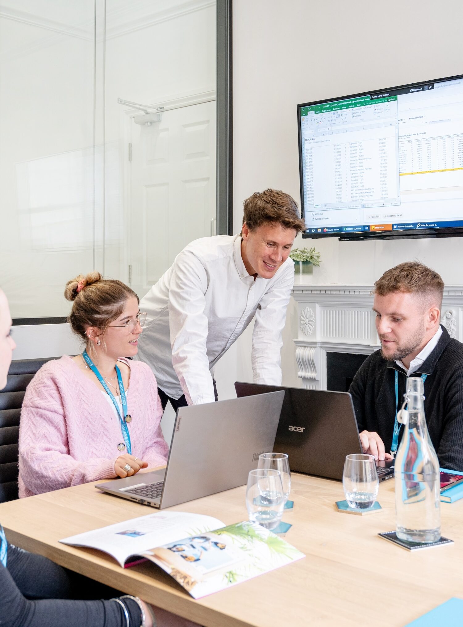 A team collaborating in a bright, fully-equipped meeting room at Square Works, a hub for professionals seeking premium office space in Bristol with access to The Square Club's exclusive amenities.