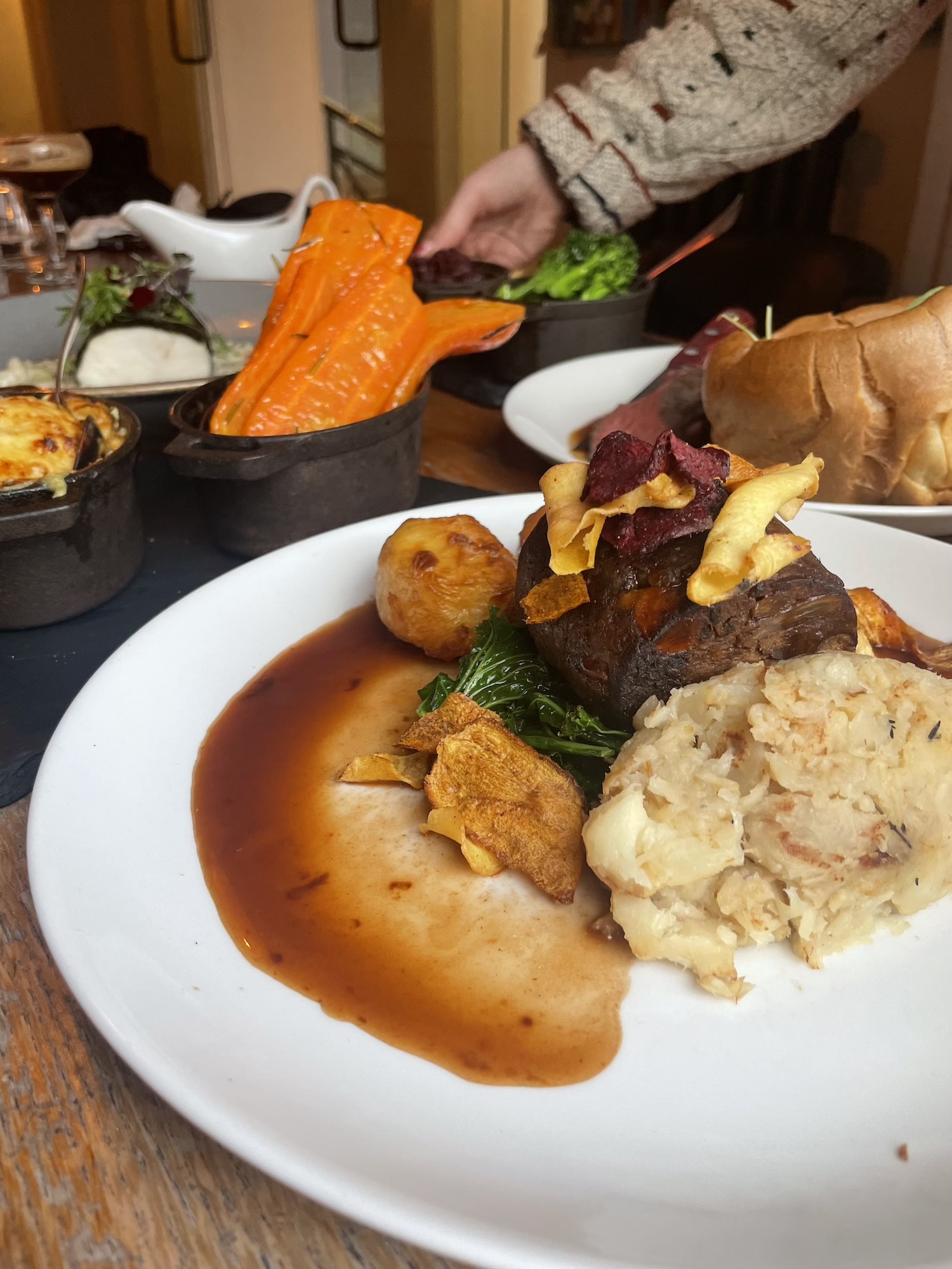 A beautifully plated vegetarian roast at The Square Club in Clifton, Bristol, featuring herb-crusted nut roast accompanied by creamy mashed potatoes, crispy roasted parsnips, wilted greens, and a rich vegetarian gravy. This dish is part of The Square Club's set Sunday menu, crafted with the finest seasonal ingredients and served with all the traditional trimmings. Perfect for vegetarians and vegans seeking the best Sunday lunch in Bristol, this dish is a standout choice at this top-rated Sunday roast venue.