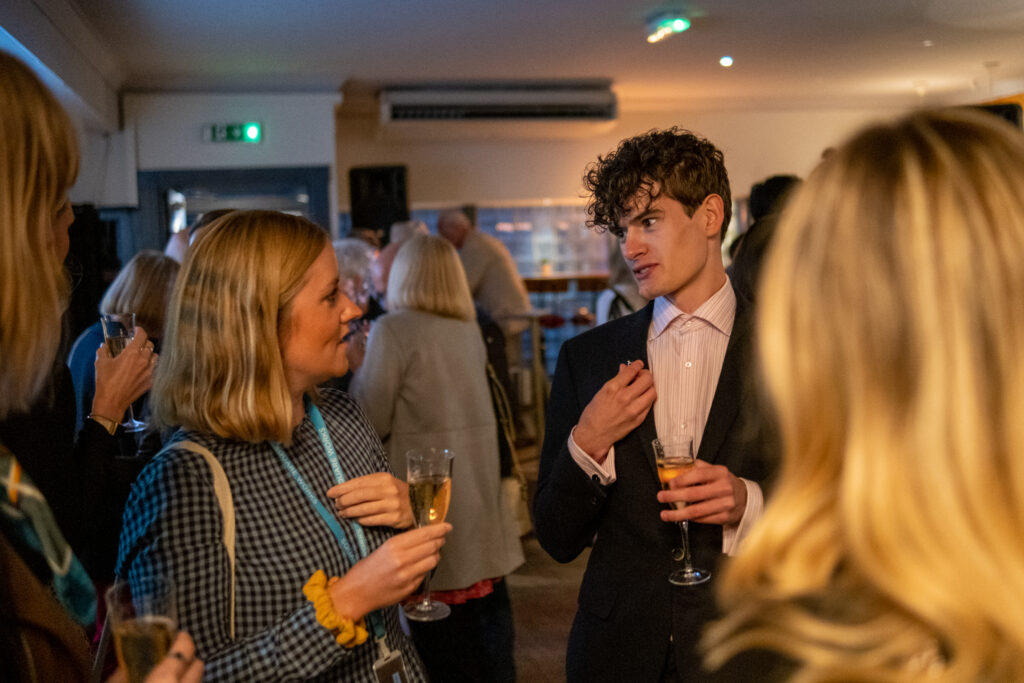 Professionals networking at The Square Club in Bristol, engaging in conversation over glasses of prosecco at a lively business event. The Square Club hosts exclusive networking events in Bristol, bringing together entrepreneurs, creatives, and professionals in an elegant members-only venue.